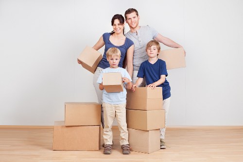 Professional movers handling furniture during a Redbridge flat removal