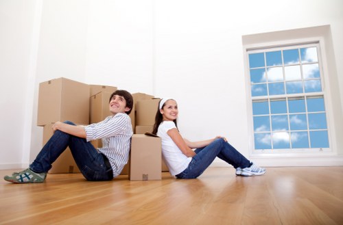 Organised home moving boxes labeled by room in Redbridge