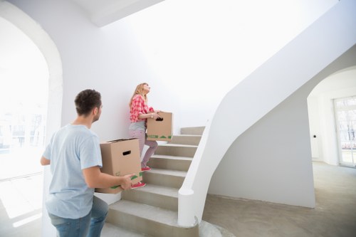 Professional removals service organizing boxes and furniture for transport