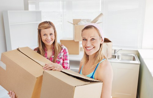 Professional movers loading furniture during urgent removals